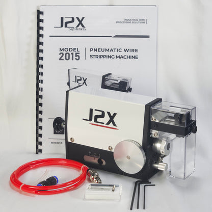 J2X Pneumatic Wire Stripping Machine Model 2015 kit, featuring the white and black pneumatic machine with a clear plastic safety shield and scrap container, a red pneumatic tube, accessories, and the original instruction manual.